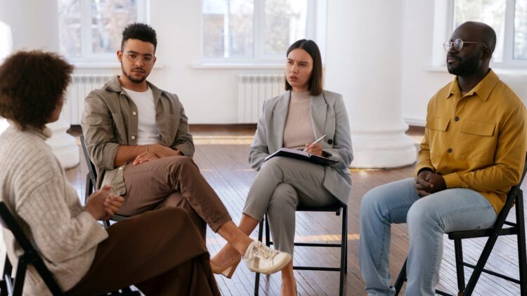 A woman sharing her experiences during a 12-step meeting.